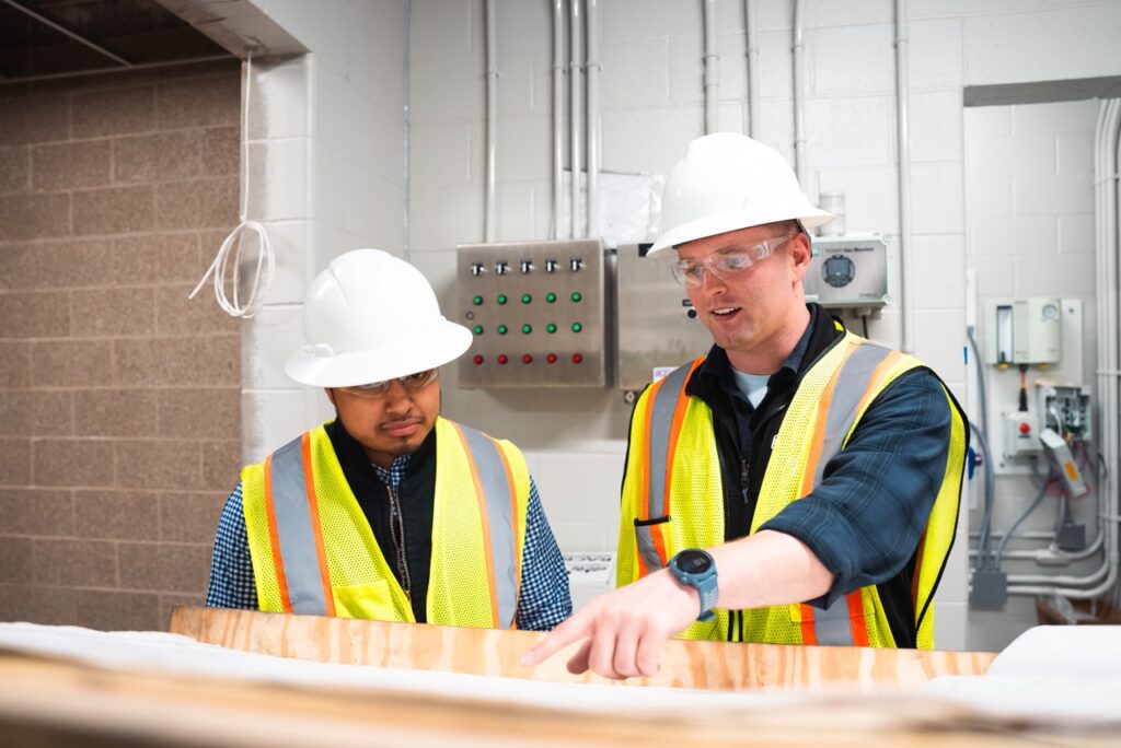 Two In Control engineers reviewing equipment in a water treatment facility