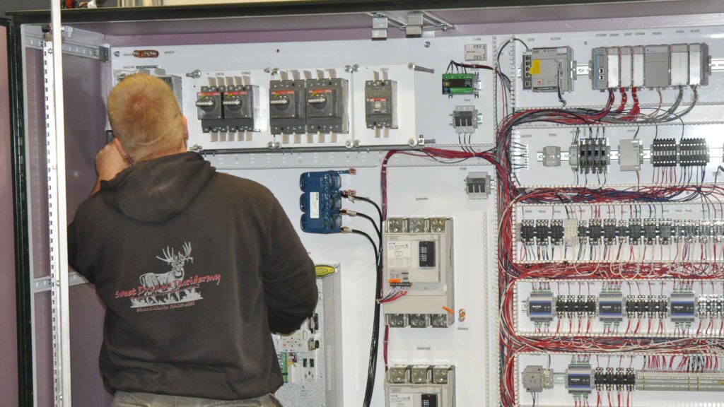 A technician assembling electrical components in an In Control control panel